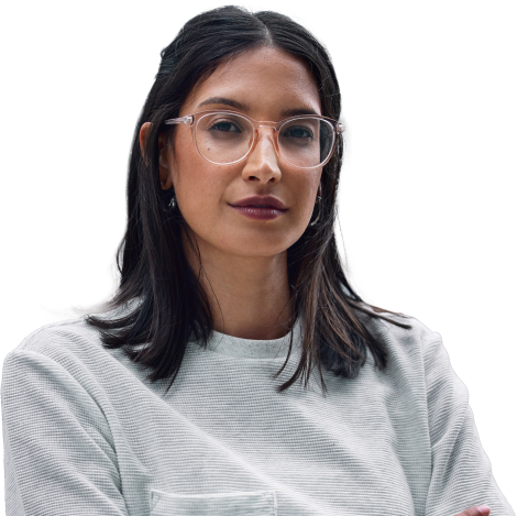 Image of woman with round-framed glasses and dark hair, wearing a gray sweater